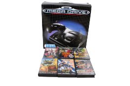 A Sega Mega Drive computer game console and a selection of games.