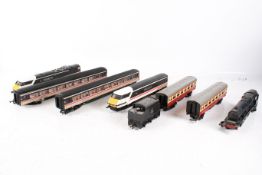 An assortment of 00 gauge locomotives and carriages.