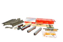 An assortment of 00 gauge carriages, rolling stock and layout accessories.