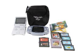 Two Nintendo Game Boy consoles and games.