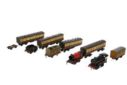 A collection of 0 gauge locomotives, carriages and rolling stock.