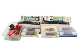 An assortment of N gauge locomotives, wagons and accessories.