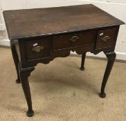 A George III oak lowboy, the two piece top with moulded edge over a central slim drawer,