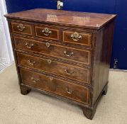An 18th Century walnut chest, the later quartered and cross-banded top with reeded edge,