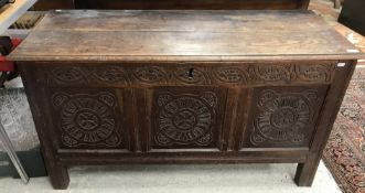 An 18th Century oak coffer, the two plank top on iron ring hinges with moulded edge,