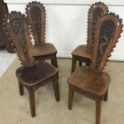 A set of four early to mid 20th Century carved oak hall or spinning chairs,