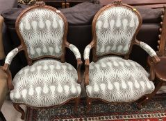A pair of 19th Century French walnut framed elbow chairs in the Louis XV taste,