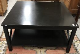 An OKA black lacquered coffee table, on square supports, united by an undertier,