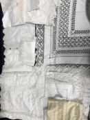 A collection of household linens to include voile table cloth with lace edging and inserts,