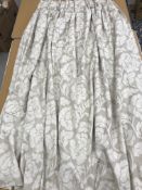 A pair of linen type foliate decorated cream and beige lined curtains with fixed triple pencil