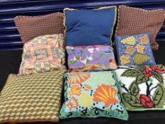 Two boxes, one containing nine cushions including six hand-stitched tapestry examples,