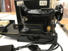 A portable Singer sewing machine Model 221K 