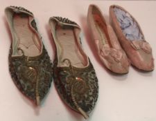 A pair of pink satin child's shoes with