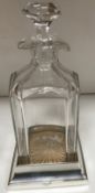 A cut glass faceted decanter and stopper