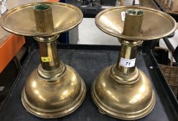 A pair of brass squat candlesticks with drip trays on inverted bell shaped bases 24 cm high and a