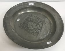 A 19th Century pewter dish, decorated with two women in 16th Century dress, one with a dog,