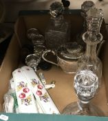 A box containing various decanters,