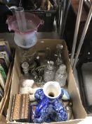 A box containing an early 20th Century oil lamp with cranberry and clear glass shade,