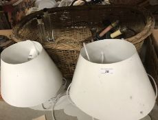 A basket containing various wooden table lamps,