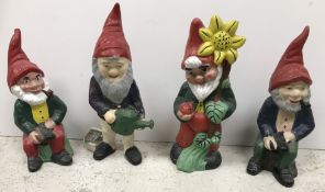 A box containing assorted painted garden gnomes and first day covers,