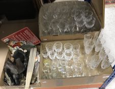 Two boxes of assorted glassware to include various cut glass wines, assorted shot glasses, etc.