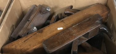 A box containing assorted antique wood planes and moulding planes