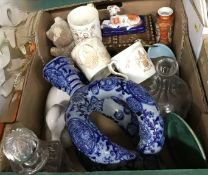 A box of assorted china and glass to include a Mettlach style puzzle type jug, a model of a duck,