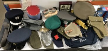 A box containing various reproduction military caps to include an RAF cap,