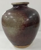 A studio pottery sang de boeuf glazed vase with narrow flared rim,