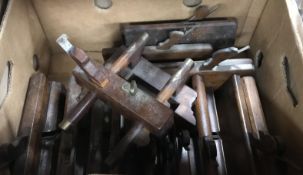 A box containing assorted wooden moulding planes to include a plough plane,