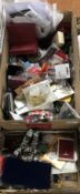 Two boxes of reproduction military badges, medals, buttons, etc.
