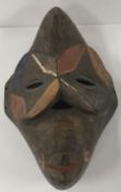 A Cameroon Tika carved and painted wooden mask as a baboon, 35.