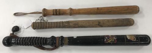 A large black painted and gilt decorated truncheon bearing transfer decorated Royal crest inscribed