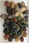 Approximately 45 various hardstone eggs and 3 coloured glass eggs