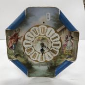 A 19th Century French pottery clock decorated with young woman and suitor,