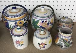 A Poole Pottery sugar bowl and cover with cane handle bearing Christies label to underside 