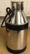 A stainless steel milk churn with swing handle,