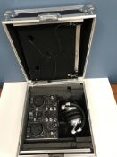 A cased Hercules DJ control MP3 E2 twin deck with Behringer HPX2000 headphones and a leather