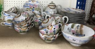 An early to mid 20th Century Japanese eggshell china tea set comprising twelve cups and saucers,