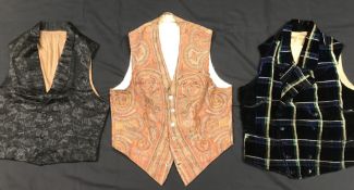 A box containing three 19th Century gentleman's waistcoats, one tartan velvet with plain lining,