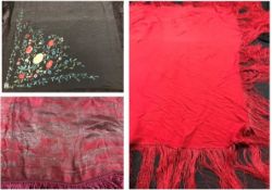 Three shawls, the first in pink and gold brocade with deep pink fringing (folded over and stitched),