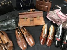 A box containing a leather attaché case, nine handbags,