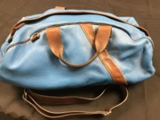 A blue leather Stjx duffle or 