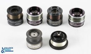 A selection of fixed spool spare spools as follows: 2x Daiwa Procaster Evo 3008A; 2x Shimano 4000;