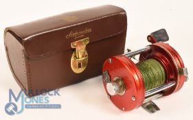 ABU Ambassadeur No 6000 multiplier reel in red and chrome finish, stamped 020801 to foot, star drag,
