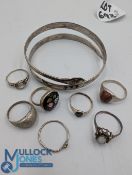 Collection of vintage silver and white metal rings and bangle: a snake bangle decorated with palm