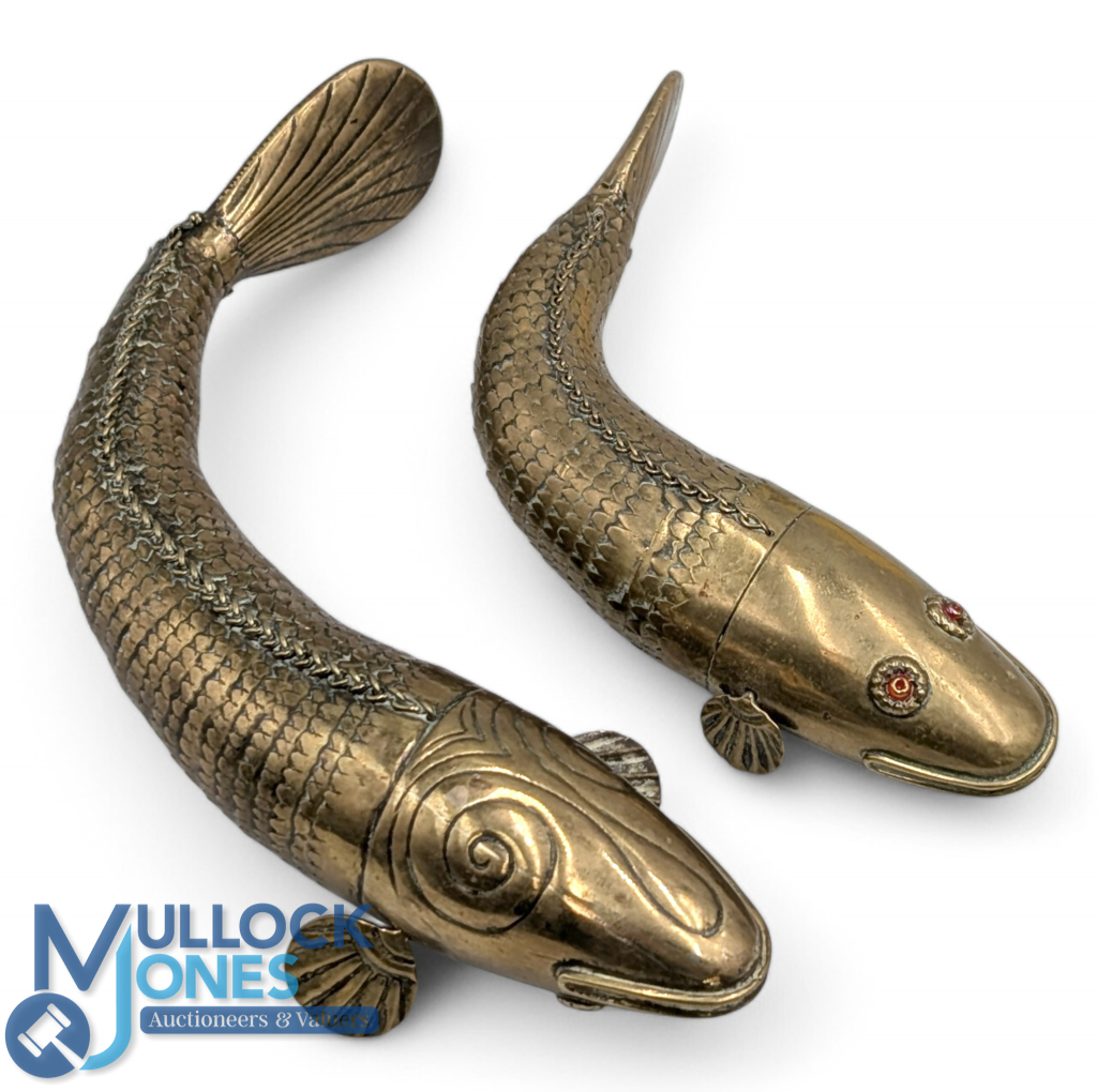 Pair of Medina pattern brass articulated fish a 7" and 9" examples with red paste eyes, appears