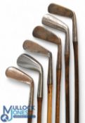 6x Assorted irons incl an A Crombie round backed cleek showing the Spalding Anvil mark, lofting