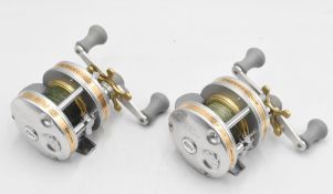 2x ABU Ambassadeur UC 4601C multiplier reels both without foot markings, in silver and gold trim
