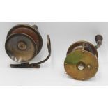 A vintage Pfleuger Temco free spool brass surf casting reel, counter balanced wooden handle, on/